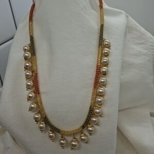 Necklace Goldtone and pearl with crystals inside the chain.